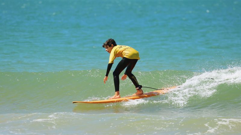 a man riding a wave on a surfboard in the ocean