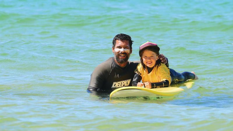 a person riding a surf board on a body of water