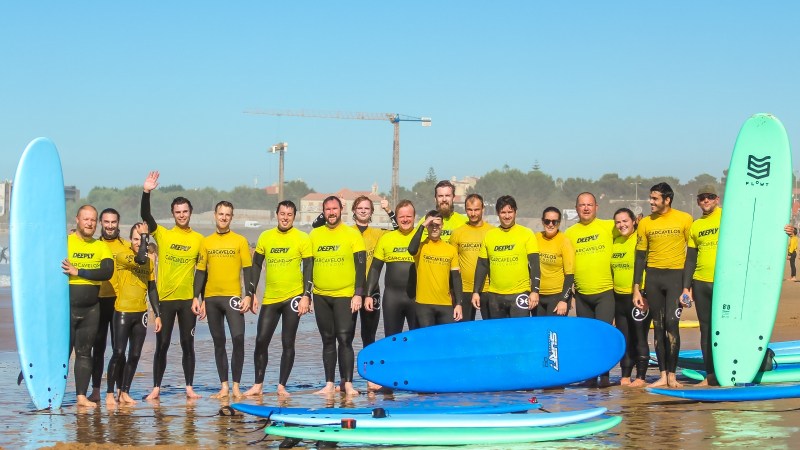 a group of people standing on a beach posing for the camera