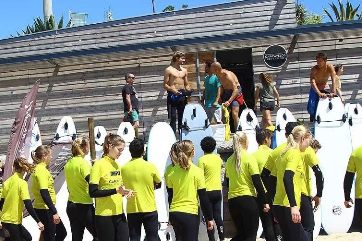 a group of people standing in front of a crowd posing for the camera