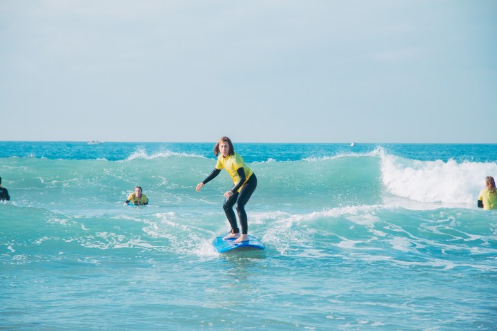 a man riding a wave on a surfboard in the ocean
