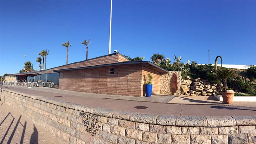 a man riding a skateboard up the side of a building