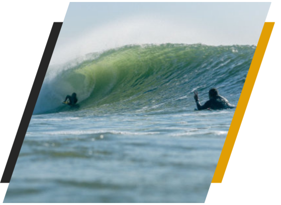 a man riding a wave on a surf board on a body of water