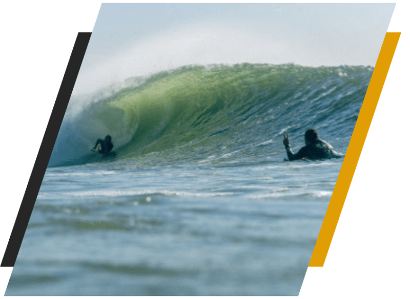team6 a man riding a wave on a surf board on a body of water